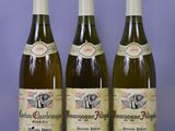three bottles of wine sitting on a table next to each other
