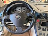 steering wheel of a car with dashboard controls and gauges