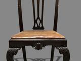 an image of a chair with a wooden seat on a gray background