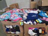 a pile of clothing in a cardboard box on the floor