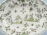a green and white plate with a picture of a man and a woman