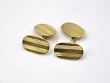 a pair of gold cufflinks on a white background