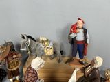 many figurines of people and animals on a shelf