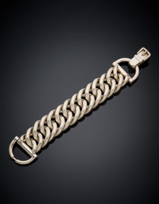 a gold chain bracelet with a clasp on a black background