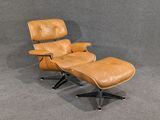 an image of a brown leather chair and ottoman in a room