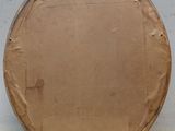 a large round cardboard object sitting on a white surface