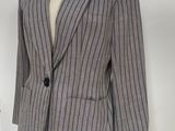 a suit on a mannequin stand with a stuffed animal