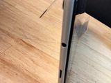 a laptop computer sitting on top of a wooden table
