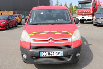 a red van with a yellow star on the front parked in a parking lot