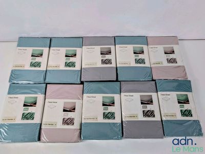 a lot of folded sheets on a white table