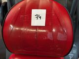 a red seat on a red scooter in a store