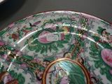 a plate with a picture of a woman on it on a table