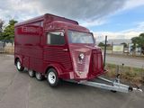 a red food truck that is parked in a parking lot