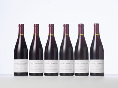 six bottles of red wine lined up in a row