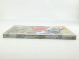 three books stacked on top of each other on a white surface