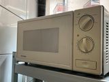 a microwave sitting on top of a counter in a kitchen