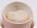 someone is holding a cup of coffee with a heart on it