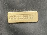 a close up of a metal tag on a piece of cloth