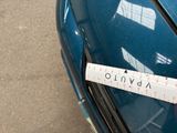 a measuring tape on the front of a blue car