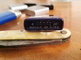 a knife with a blue handle sitting on a wooden table