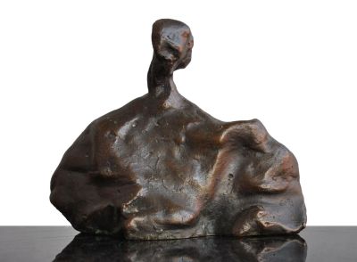a bronze sculpture of a bird sitting on a rock