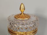 a glass jar with a gold lid on a table
