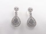 a pair of diamond earrings on a white background