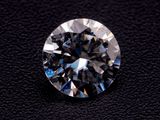 a close up of a diamond on a black surface