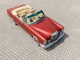 an image of a red convertible car on a brick road