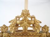a gold clock with a clock face on top of it