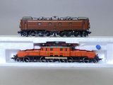 deux petits trains exposés sur une surface blanche