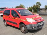 a red van parked in a parking lot with a firetruck in the background
