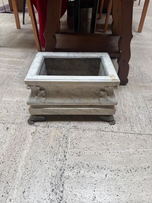 a planter on the floor in the middle of the room