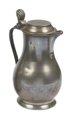an old silver pitcher with a handle on a white background