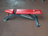 a red bench sitting on the floor of a train station