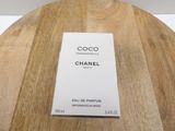 chanel coco eau de parfum spray bottle on a wooden table