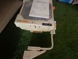 a computer on top of a table on a green carpet