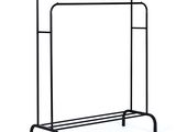 black metal clothing rack with two shelves on top of it