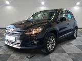 the volkswagen tiguan is parked in a garage with a checkered floor