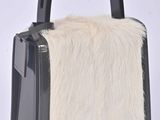 black and white handbag with fur inside on a white background