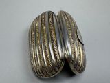 a close up of a pair of silver bracelets on a table