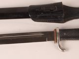 two different types of knives on a white surface