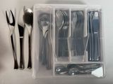 a plastic container with spoons, forks and spoons in it