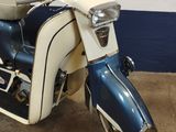 a blue and white scooter parked in a garage