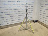 an image of a tripod stands in front of a wall with a sign