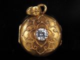 an image of a gold locke with a diamond in the center