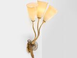 a close up of a wall light with three flowers on it