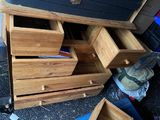 a wooden chest of drawers sitting on the ground