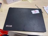 a laptop computer sitting on a desk next to a pen and paper