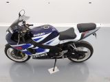 a picture of a blue and white motorcycle parked in a room